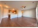 Bright, open concept living room and kitchen area with hardwood floors and a ceiling fan at 6132 Meadow Rose Ln, Charlotte, NC 28215
