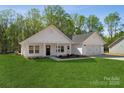 Attractive single-story residence featuring a green lawn, attached garage, and welcoming front porch at 902 Westminster Dr, Statesville, NC 28677