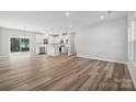 Bright, open-concept living area with modern floors, seamlessly blending into a stylish kitchen and dining space at 902 Westminster Dr, Statesville, NC 28677