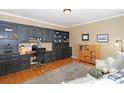 Well-appointed office with custom built-in cabinetry, hardwood floors, and ample workspace at 10625 Olde Irongate Ln, Mint Hill, NC 28227