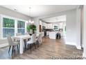 Open dining room with wood floors and view of the kitchen at 11032 Gary Player Dr # 961, Lancaster, SC 29720