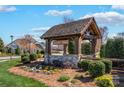 Community entrance sign with stone base, wood beams, and landscaping, welcoming residents and visitors at 111 Bell Chase Ln, Statesville, NC 28677