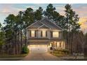 Charming two-story home with stone accents, a well-manicured lawn, and a welcoming front porch at 111 Bell Chase Ln, Statesville, NC 28677
