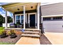 Inviting front porch with seating area and stone accents on the facade at 116 Dublin Ct, Statesville, NC 28677