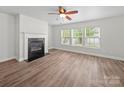 Bright and airy living room with modern flooring, a fireplace, and large windows for ample sunlight at 118 Glade Valley Ave, Mooresville, NC 28117