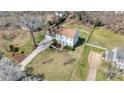 Aerial view of a traditional home with a long drive and large manicured lawn in a suburban neighborhood at 11929 Parks Farm Ln, Charlotte, NC 28277