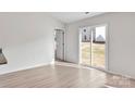 Bright room with light wood flooring and sliding glass doors that bring the outside in at 125 Jacobs Hill Pl, Troutman, NC 28166