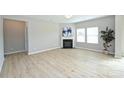 Cozy living room features a fireplace and lots of natural light from multiple windows at 1309 Afternoon Sun Rd, Matthews, NC 28104
