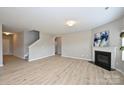 Spacious living room with fireplace, wood floors, and open layout with stairs at 1309 Afternoon Sun Rd, Matthews, NC 28104