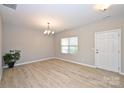 Bright living room with wood floors, chandelier, and a view to the front yard at 1309 Afternoon Sun Rd, Matthews, NC 28104