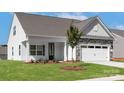 Beautiful one-story home with well-kept lawn, black front door, stone accents, and attached garage at 136 Adams Tree Way, Troutman, NC 28166