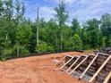 A construction site is nestled in the trees, showing a foundation being built at 14703 Keyes Meadow Way, Huntersville, NC 28078