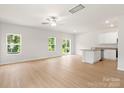 Bright, open-concept living room with hardwood floors and a modern kitchen island at 1522 Doran Ter, Richburg, SC 29729