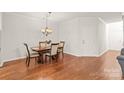 Traditional dining room features a classic chandelier, hardwood floors, and a cozy atmosphere at 16911 Commons Creek Dr, Charlotte, NC 28277