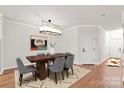 Contemporary dining room with modern lighting, stylish gray chairs, and an eye-catching art piece at 16911 Commons Creek Dr, Charlotte, NC 28277