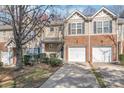 Inviting townhome with brick accents, two-car garage, and well-maintained landscaping at 16911 Commons Creek Dr, Charlotte, NC 28277