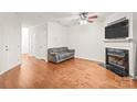 This is an unfurnished living room featuring hardwood floors and a fireplace perfect for cozy nights at 16911 Commons Creek Dr, Charlotte, NC 28277