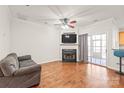 Comfortable living room featuring hardwood floors, a fireplace, and a large sliding door at 16911 Commons Creek Dr, Charlotte, NC 28277