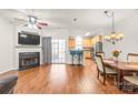 Open-concept living area with hardwood floors, fireplace, and access to the kitchen at 16911 Commons Creek Dr, Charlotte, NC 28277
