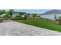 A backyard featuring a stone patio and a wrought iron fence at 1819 Lotus Ln, Denver, NC 28037