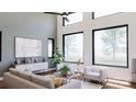 Bright living room with large windows, vaulted ceilings, modern furniture, and views of the yard at 1935 Weddington Rd # 1, Matthews, NC 28104