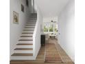 Bright entryway features hardwood floors, staircase, and view into the living area with ample natural light at 2004 Sadler Woods Ln, Charlotte, NC 28214
