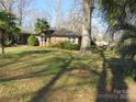 Quaint brick home with a large front yard shaded by mature trees at 215 Bailey Ave, Rock Hill, SC 29732