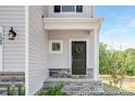 Charming home entrance with a black door, stone accents, and a welcoming wreath at 29069 Low Country Ln # 602, Lancaster, SC 29720