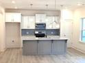 Bright kitchen featuring a center island, stainless steel appliances and white cabinets at 29069 Low Country Ln # 602, Lancaster, SC 29720
