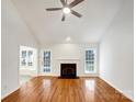 Bright living room featuring vaulted ceilings, fireplace, and gleaming hardwood floors at 3316 Creek Trail Rd, Indian Trail, NC 28079