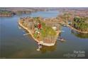 Picturesque aerial view of lake home with docks, nestled on a peninsula with lush greenery at 340 Topsail Rd, Salisbury, NC 28146