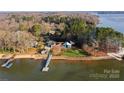 Expansive lakefront home with mature trees and dock, providing a serene waterfront lifestyle at 340 Topsail Rd, Salisbury, NC 28146