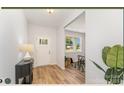 Bright entryway featuring wood flooring, a white front door, and a decorative table with a lamp at 4046 Jenison Valley Ct, Charlotte, NC 28214