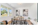 Bright office space with two art pieces on the walls, a desk and a patterned rug in front of a large window at 4046 Jenison Valley Ct, Charlotte, NC 28214