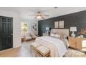 Inviting main bedroom with wood accent wall, ceiling fan, and natural light at 412 Montana Dr, Gastonia, NC 28056