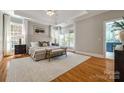 Spacious primary bedroom featuring hardwood floors, tray ceiling, and an ensuite bathroom at 4340 Sequoia Red Ln, Charlotte, NC 28226