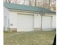 Two-car detached garage with white siding and a green metal roof and basketball hoop at 5212 Old Concord Rd, Salisbury, NC 28146