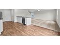 Open-concept living space featuring wood-look floors, granite countertops, and a kitchen with modern appliances at 642 Lamorak Pl, Richburg, SC 29729