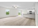 Bright living room with an adjacent kitchen and sliding glass doors leading to the backyard at 642 Lamorak Pl, Richburg, SC 29729