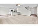 Bright, open-concept living space with a view of the kitchen and staircase at 668 Lamorak Pl, Richburg, SC 29729