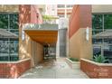 A modern brick building entrance with water feature and stylish architectural details at 701 Royal Ct # 102, Charlotte, NC 28202