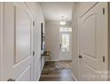 Inviting entryway with wood floors, neutral walls, console table and decorative art at 8009 Downy Oak Ln, Charlotte, NC 28269