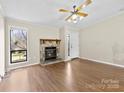 Cozy living room with stone fireplace, laminate wood floors and natural lighting at 8123 Chrisbry Ln, Charlotte, NC 28215