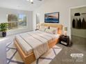 Serene main bedroom features large window, tv, walk-in closet, and neutral tones at 8813 Gerren Ct, Charlotte, NC 28217
