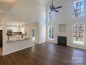 Bright living room with high ceilings, fireplace, and an open view to the adjacent kitchen area at 1000 High Brook Dr, Waxhaw, NC 28173