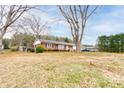 Spacious property featuring a brick home with mature trees and a large yard at 107 Destiny Ln, Shelby, NC 28150