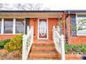 Inviting entryway with a brick facade, white railing, and decorative front door at 107 Destiny Ln, Shelby, NC 28150