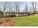 Well-maintained brick home with green shutters and a lush, landscaped front yard at 117 Gwyn St, Wingate, NC 28174