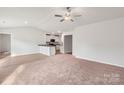 Spacious living room featuring a ceiling fan and a seamless transition to the kitchen area at 117 Lightning Dr, Shelby, NC 28152
