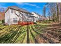 Expansive backyard featuring a wooden deck, lush lawn and mature trees, perfect for outdoor entertaining at 14333 Maclauren Ln, Huntersville, NC 28078